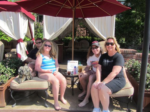 family at poolside cabana