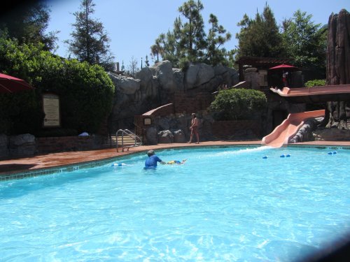 family on slide at the pool