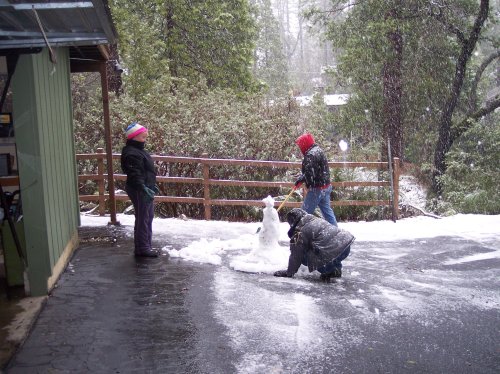 Family trying to build a snowman 