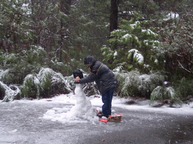 Jonny applying finishing touches to snowman 