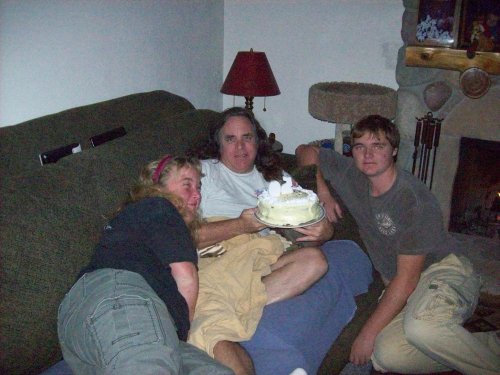 Dad blowing out the bonfire on his birthday cake 