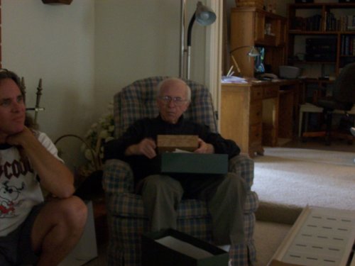 Grandpa opening presents at his birthday party 