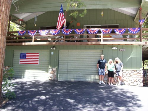 Family in front of festive cabin 