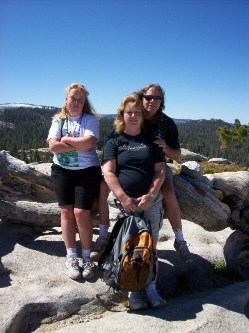 Mom, dad and Melissa on Jeffrey Pine log 