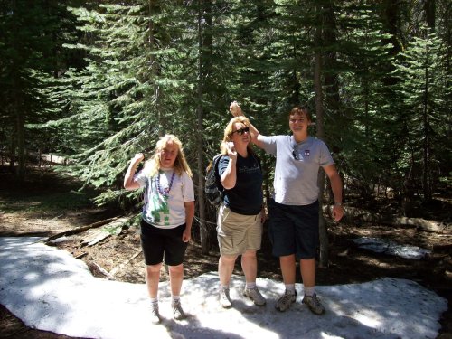 Family playing in snow in July 