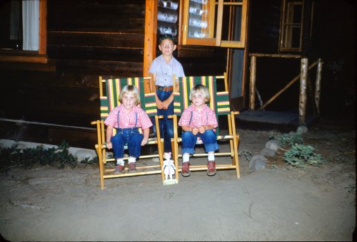 Kids outside of cabin 