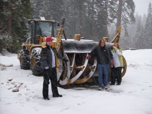 Family by giant snowblower 